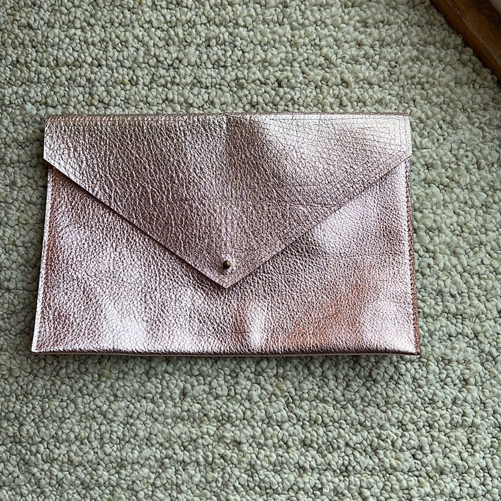Molly M s laser cut pink metallic leather clutch.